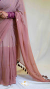 Pink saree with gold accents on a white background