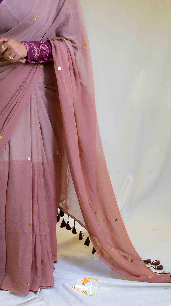 Pink saree with gold accents on a white background