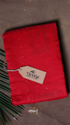 Red fabric with a brand tag on a brown background