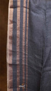 Close-up of a dark blue fabric with horizontal stripes on a brown background