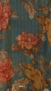 Close-up of a floral pattern with pink and yellow flowers on a blue background