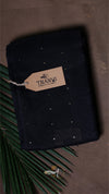 Black fabric with a brand tag on a textured surface
