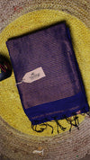 Blue and black striped towel with a brand tag on a textured yellow surface