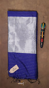 Blue and gray striped fabric with a colorful needle case on a brown background