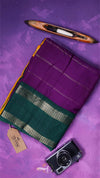 Purple and green fabric with a camera and pencil on a purple background