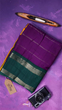 Purple and green fabric with a camera and pencil on a purple background