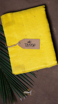 Yellow fabric with a 'THANVI' tag on a brown background
