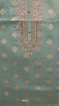 Teal fabric with gold embroidery and patterns