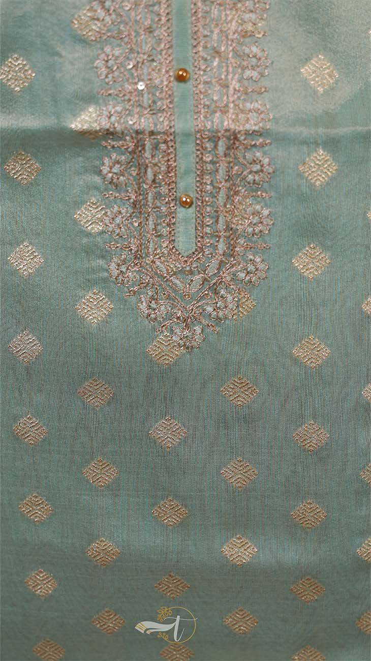Teal fabric with gold embroidery and patterns