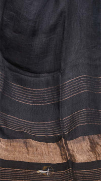 Close-up of a dark fabric with brown stripes and a brand logo.