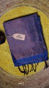 Blue and red striped towel with a tag on a textured surface