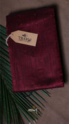 Maroon fabric with a 'THANVI' tag on a dark background