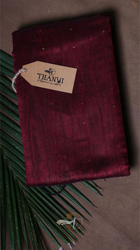 Maroon fabric with a 'THANVI' tag on a dark background