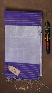Purple and gray striped towel with a tag on a brown background