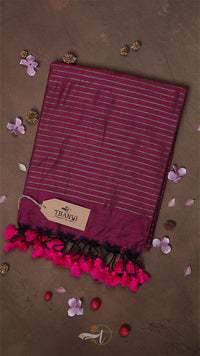 Striped scarf with pink tassels on a brown background