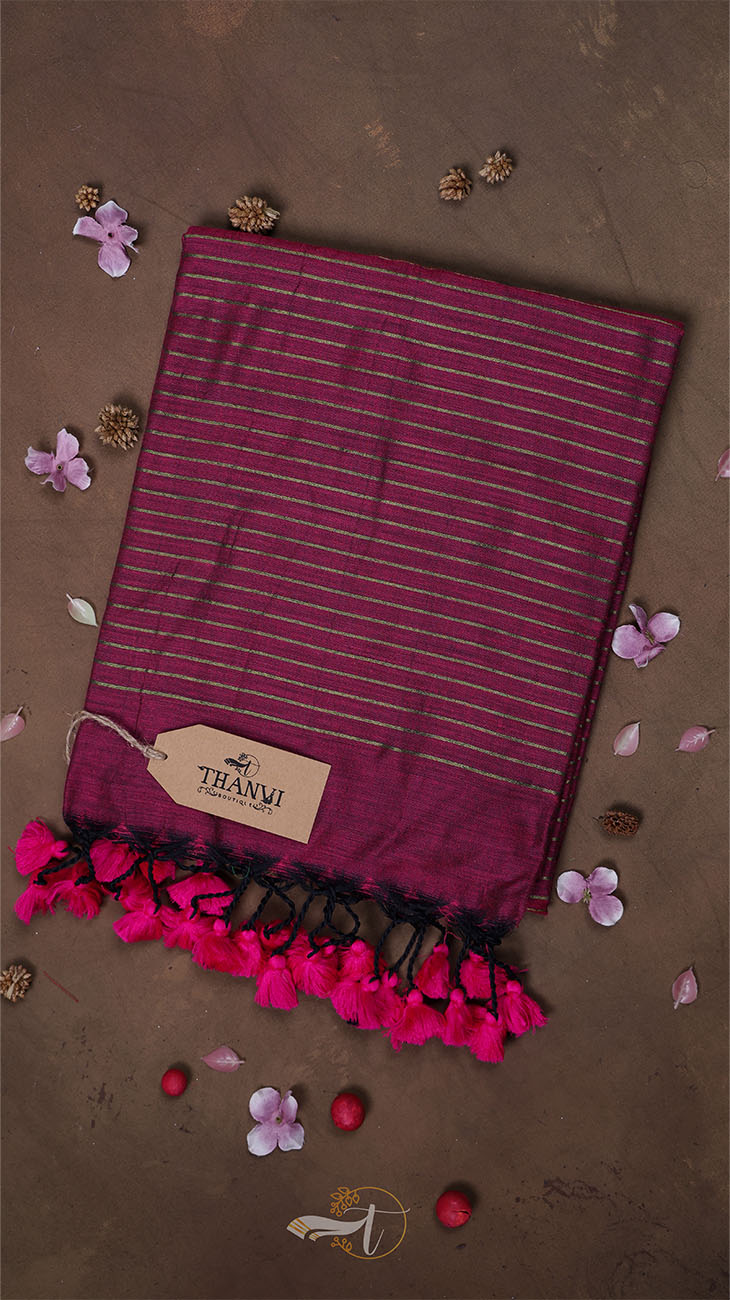 Striped scarf with pink tassels on a brown background
