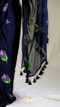 Navy blue fabric with purple floral patterns and tassels on a white background