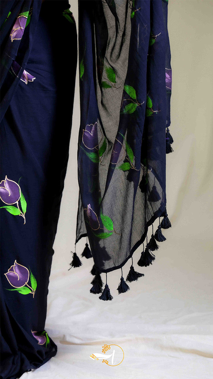 Navy blue fabric with purple floral patterns and tassels on a white background
