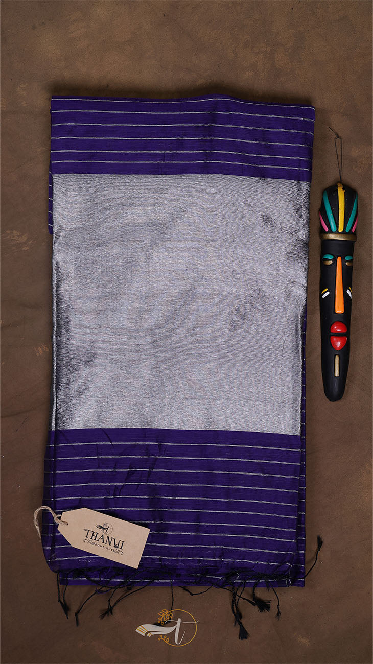 Striped fabric with a colorful handle tool on a brown background