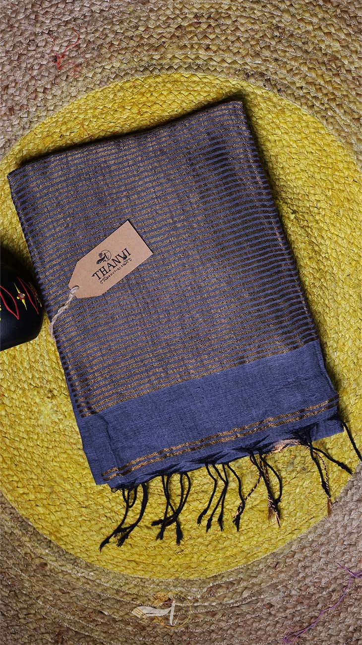 Blue and brown scarf with a brand label on a textured yellow and brown background