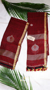 Red saree with gold border and leaf decorations on a white background