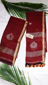 Red saree with gold border and leaf decorations on a white background