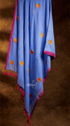 Blue fabric with orange and pink patterns on a brown background