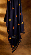 Navy blue scarf with orange and yellow floral patterns on a brown background