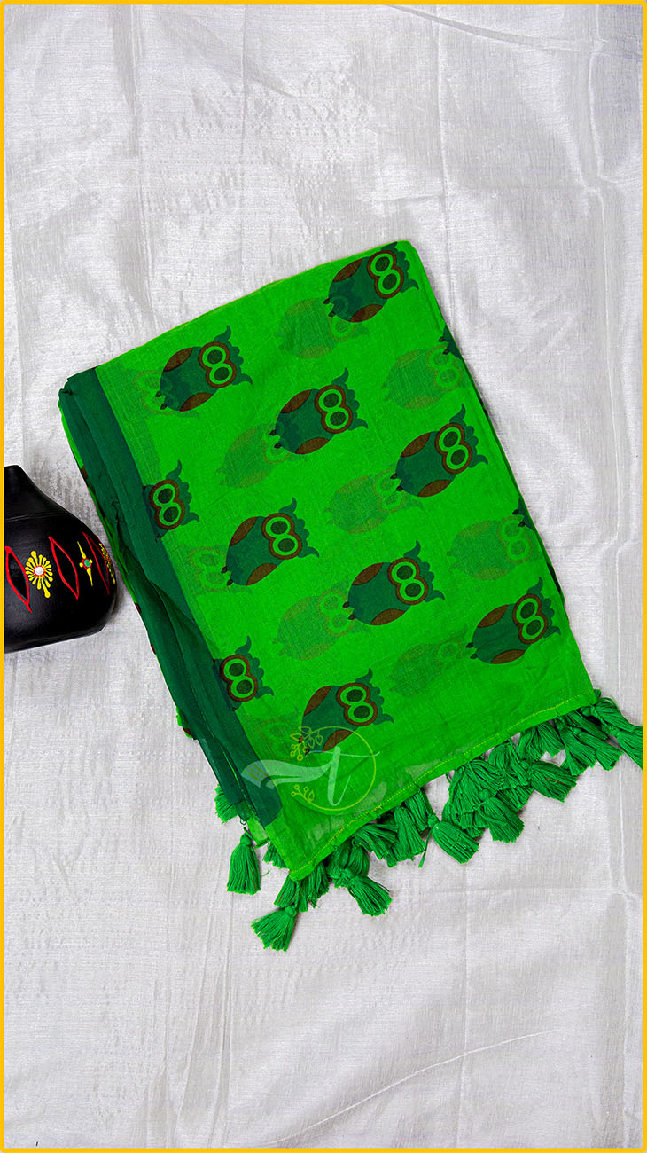 Green scarf with owl pattern on a white fabric background
