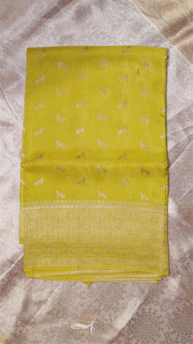 Yellow saree with subtle patterns on a textured surface