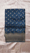 Blue fabric with feather pattern on a textured surface