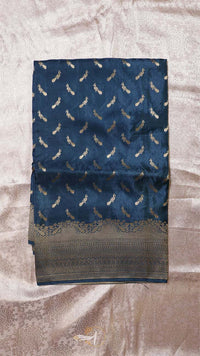 Blue fabric with feather pattern on a textured surface