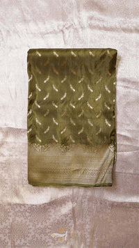 Green saree with feather pattern on a textured surface