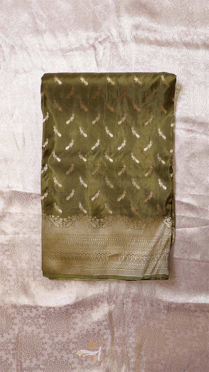 Green saree with feather pattern on a textured surface