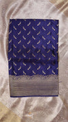 Blue saree with white patterns on a beige fabric background