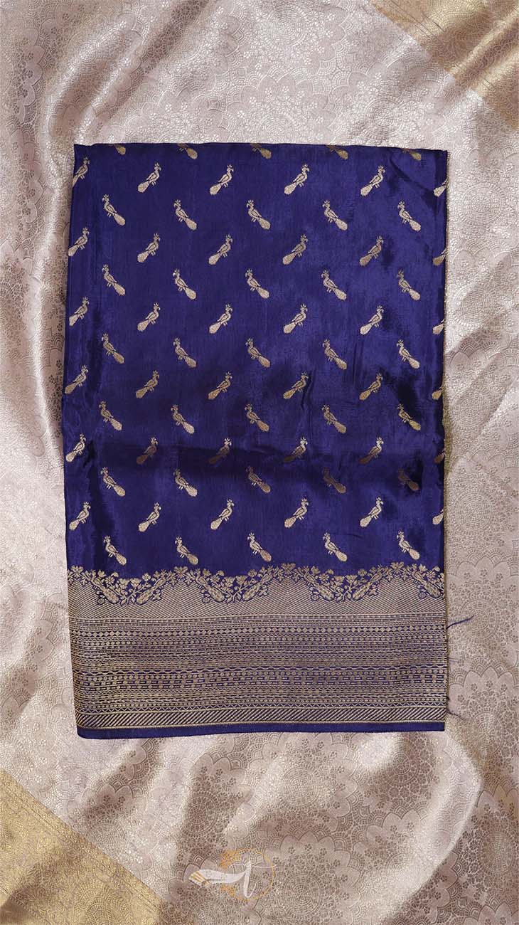 Blue saree with white patterns on a beige fabric background