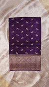 Purple fabric with white dog patterns on a beige background