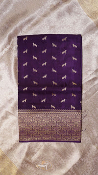 Purple fabric with white dog patterns on a beige background