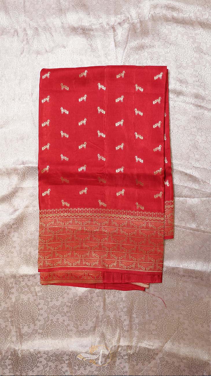Red fabric with white patterns on a textured beige background