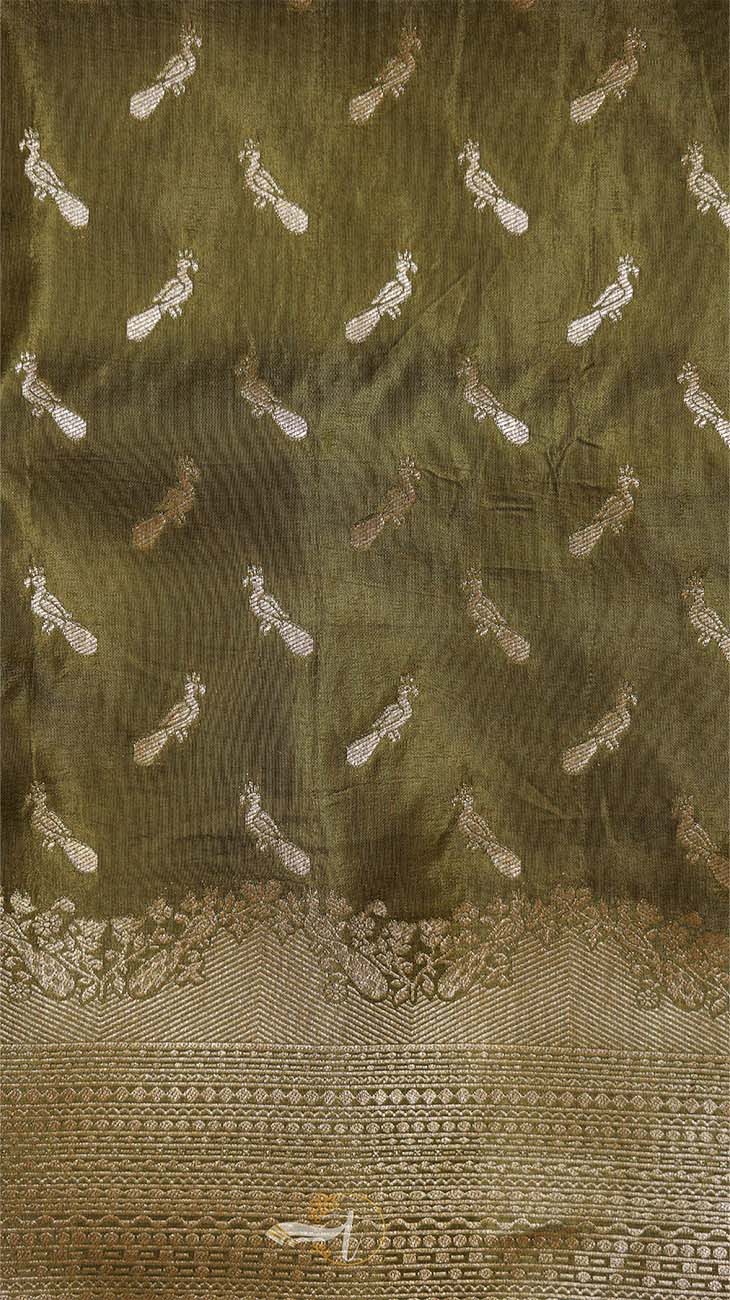 Decorative fabric with intricate patterns on a green background