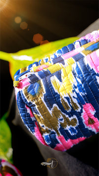 Close-up of a colorful fabric with intricate patterns and vibrant colors.