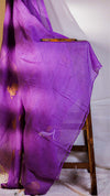 Purple fabric draped over a wooden chair against a white background