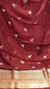 Maroon saree with gold border and white floral patterns
