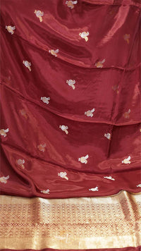Maroon saree with gold border and white floral patterns
