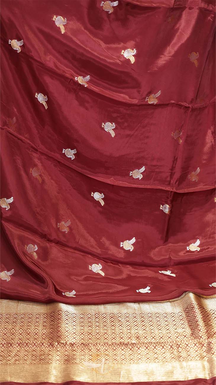 Maroon saree with gold border and white floral patterns