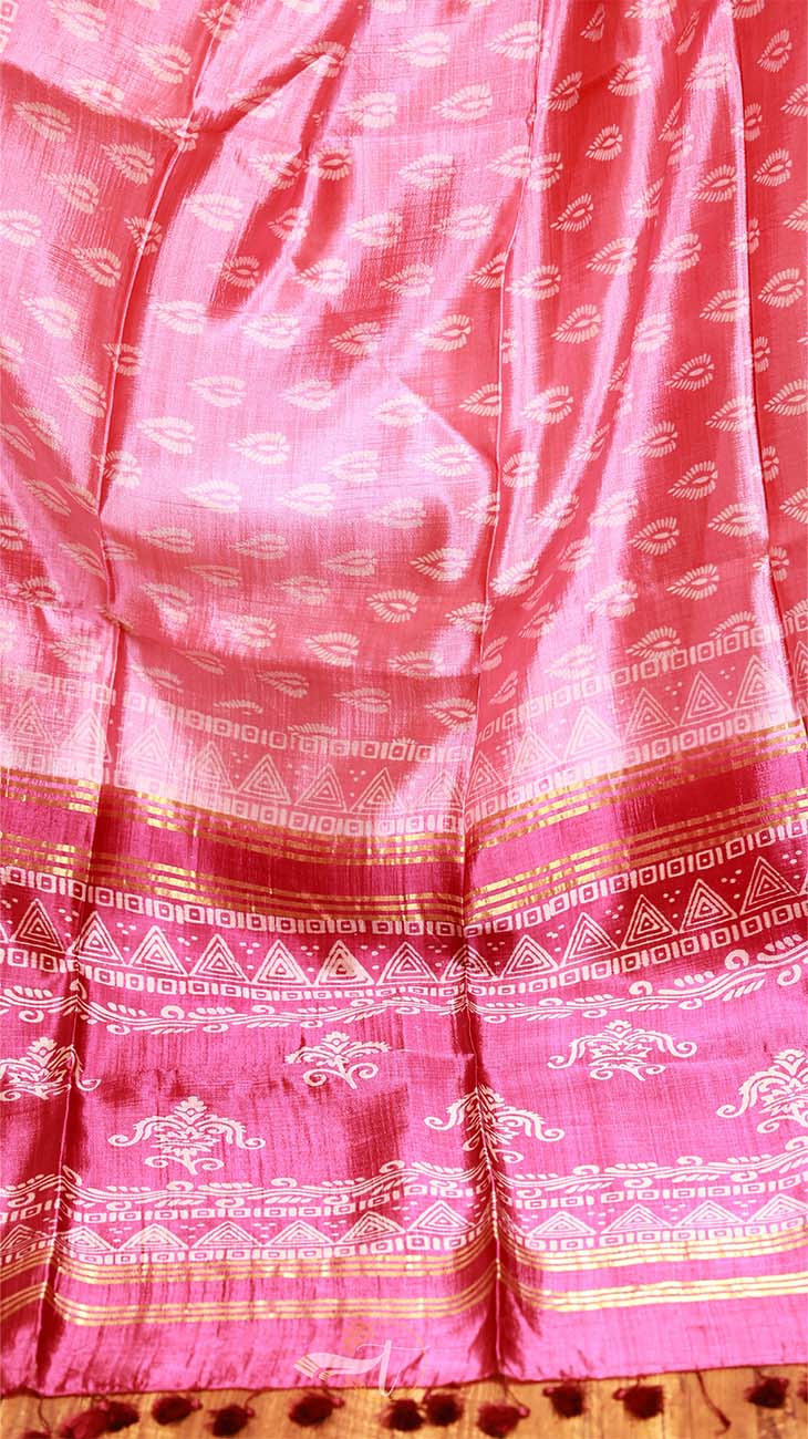 Pink fabric with white patterns and a border