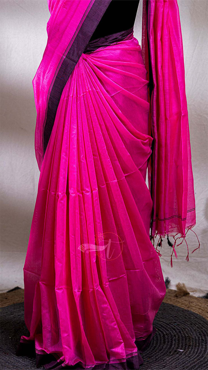 Pink saree with a black border on a plain background